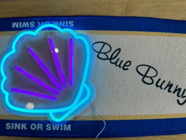 seashell neon light on surfing board